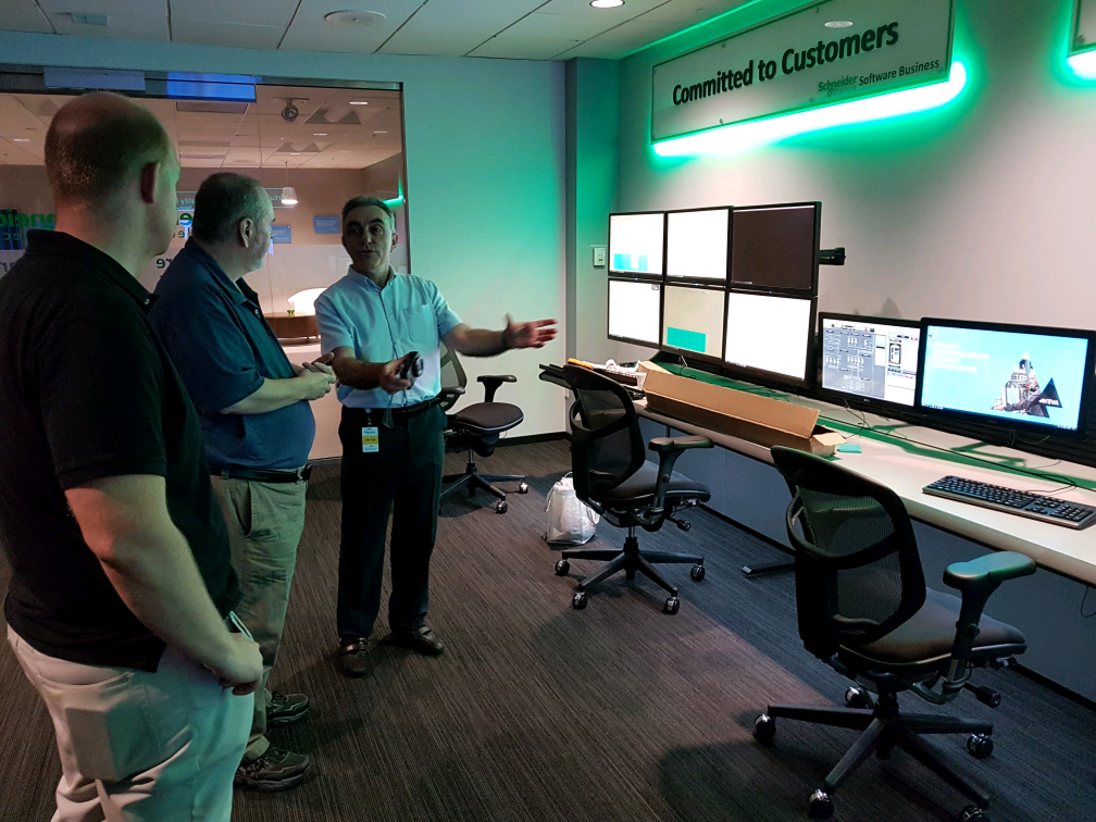 A control-room demo space with wall-mounted monitors — the operational context AVEVA's products run in